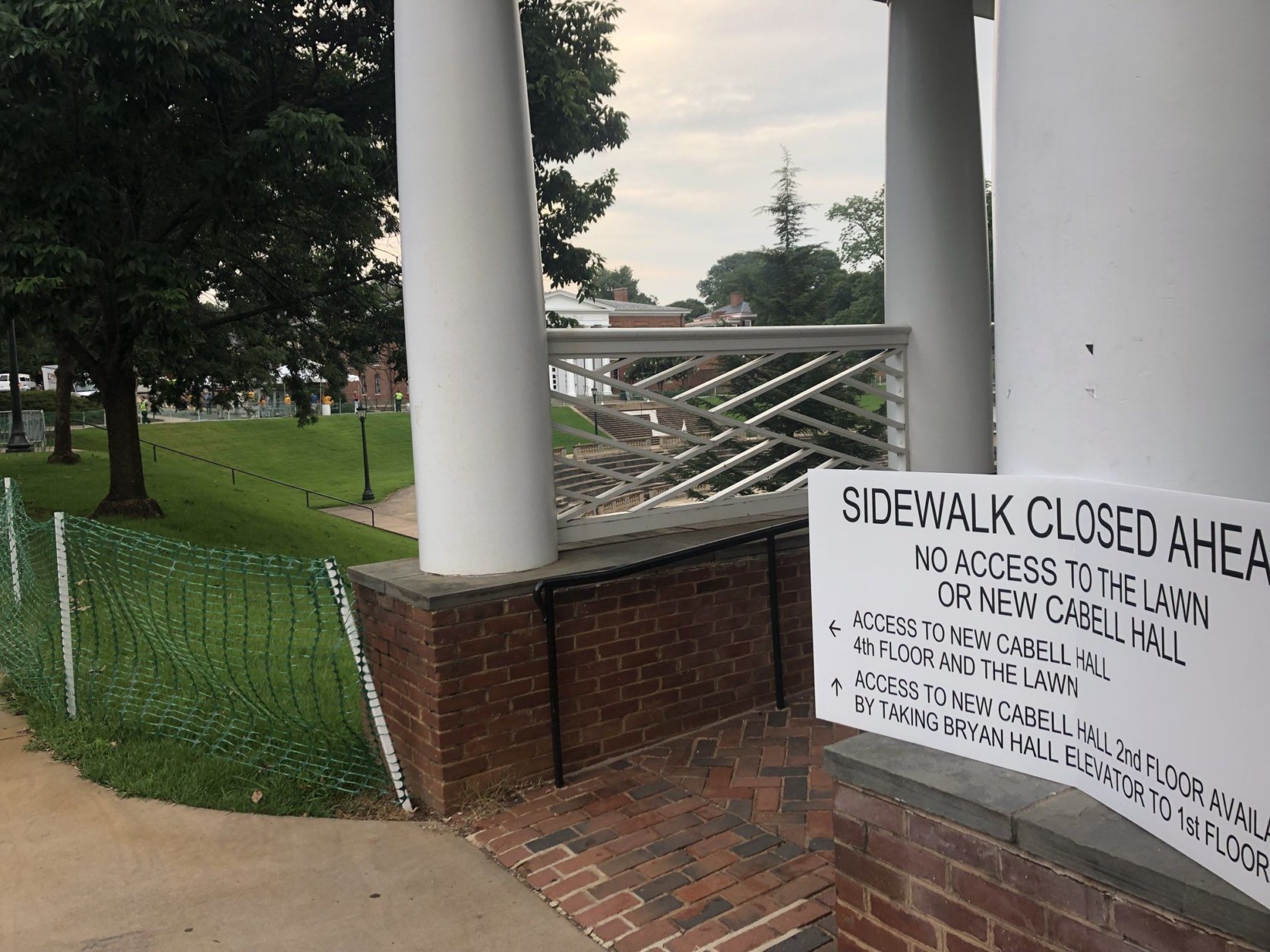 A sign warning visitors that a sidewalk is closed is seen near the amphitheater for Saturday morning's "The Hope that Summons Us" event at the University of Virginia. It comes one year after white supremacists marched through the Grounds with tiki torches, and a day before anniversary of Heather Heyer’s death. (WTOP/Max Smith)