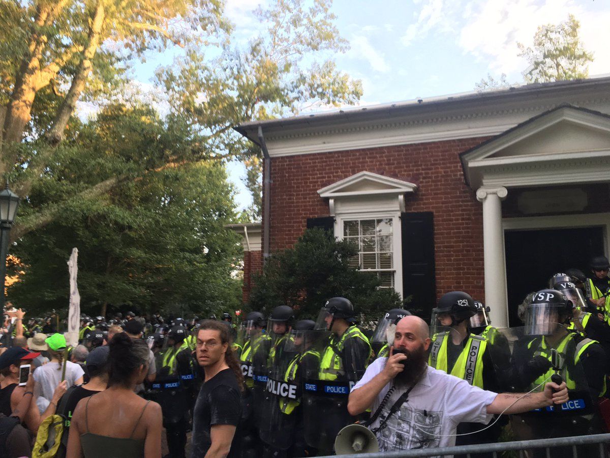 Attendees moved away from the permit area during the "Rally for Justice" at University of Virginia on Saturday, Aug. 11, 2018, drawing concern from law enforcement. (WTOP/Max Smith)