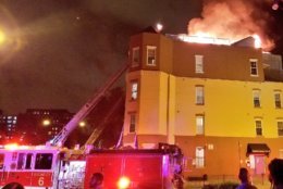 Firefighter responded to the fire on the roof deck of two four-story dwellings around 12 a.m. Monday. (Courtesy DC Fire and EMS) 
