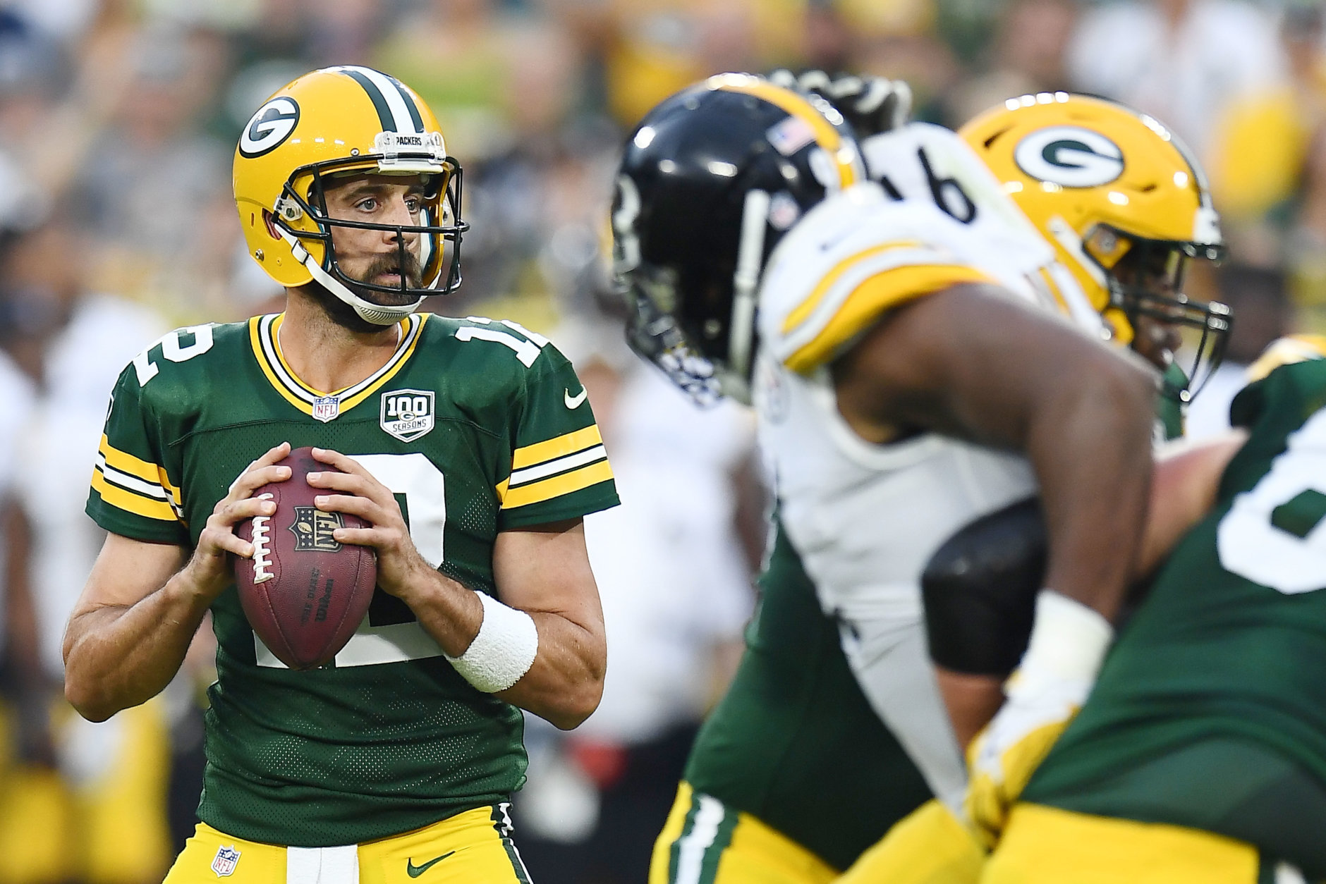 GREEN BAY, WI - AUGUST 16:  Aaron Rodgers #12 of the Green Bay Packers drops back to pass during the first quarter of a preseason game against the Pittsburgh Steelers at Lambeau Field on August 16, 2018 in Green Bay, Wisconsin.  (Photo by Stacy Revere/Getty Images)