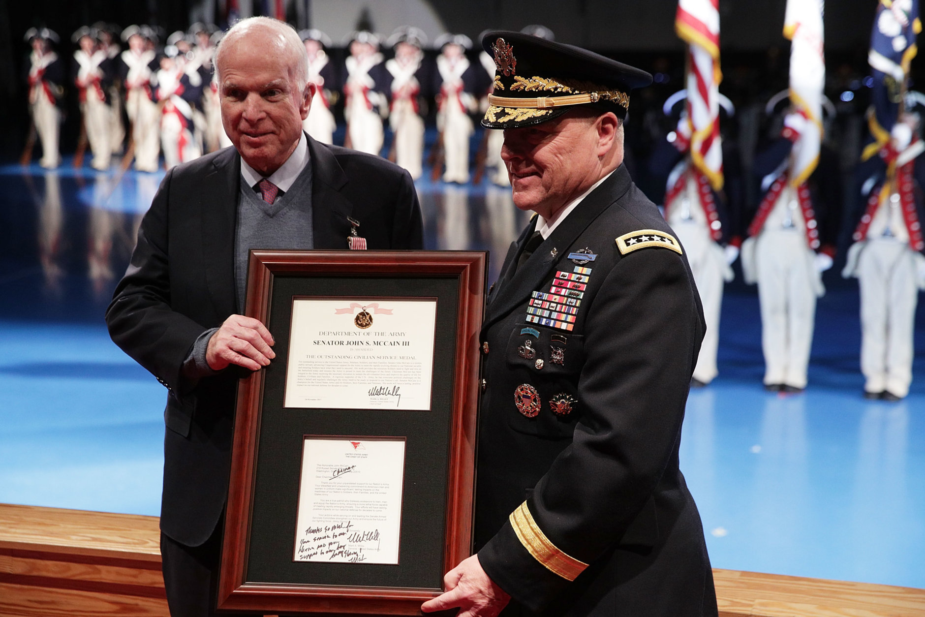 U.S. Army Chief of Staff Gen. Mark A. Milley (R) presents Sen. John McCain (R-AZ) (L) with the Outstanding Civilian Service Medal during a special Twilight Tattoo performance Nov. 14, 2017 at Fort Myer in Arlington, Virginia. Sen. McCain was honored for over 63 years of dedicated service to the nation and the U.S. Navy.  (Photo by Alex Wong/Getty Images)