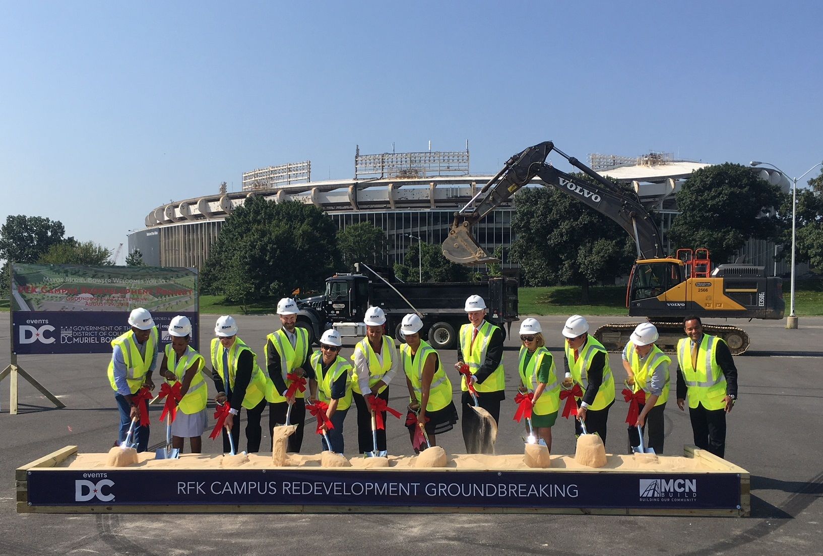 City officials take part in a groundbreaking ceremony in RFK's Lot 7. (WTOP/Noah Frank)