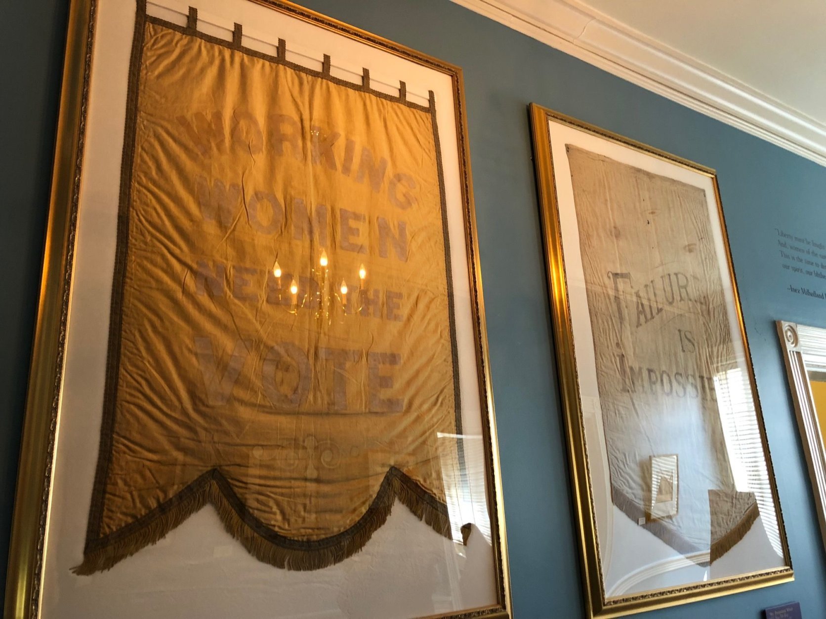 Banners from a 1913 march held a day before Woodrow Wilson's inauguration decorate the wall. The 19th Amendment, which women the right to vote, was ratified on August 26, 1920. 