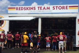 More than an hour before the gates opened, hundreds of people stood in line with the hopes of getting a good spot inside the Bon Secours facility where the Redskins practice. They had memorabilia ready for autographs and phones ready to snap pictures. (WTOP/John Domen)