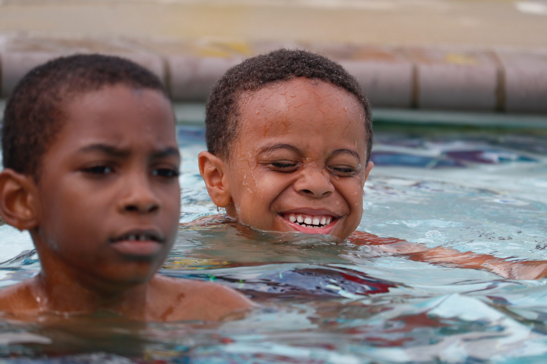 A group of boys surprised themselves, bobbing their faces into the water, popping up for air and bursting into smiles and laughter as they mastered their new skill. (WTOP/Kate Ryan)
