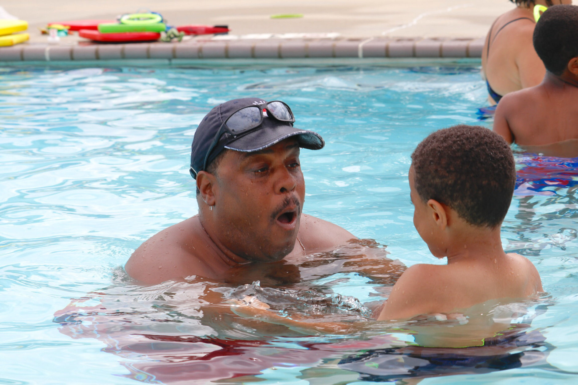 Aquatics instructor Bobby Broome was already in the water, and he called out to the kids, "Listen to me carefully. Are you listening?" (WTOP/Kate Ryan)