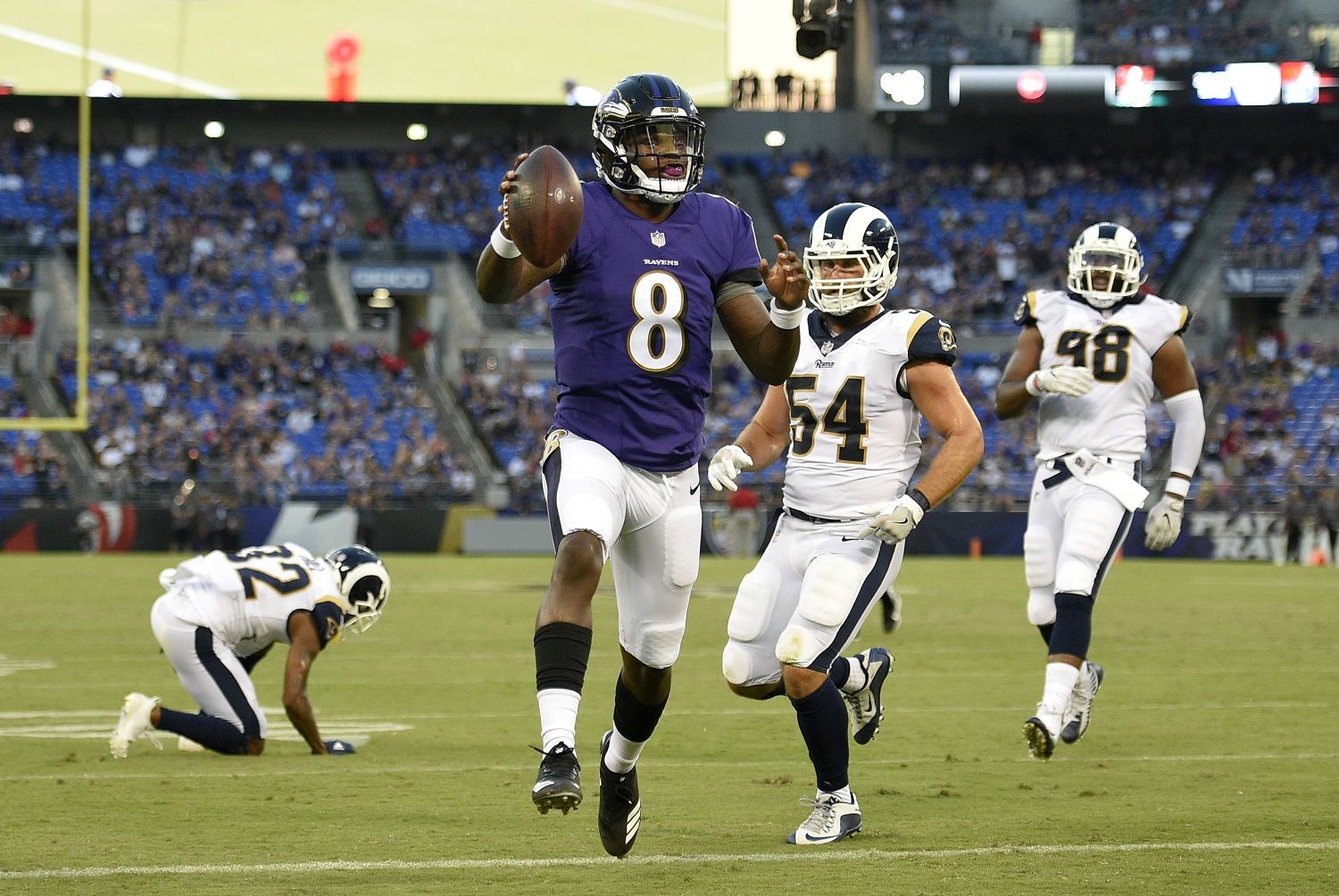 Baltimore Ravens quarterback Lamar Jackson (8) scores a touchdown in the first half of a preseason NFL football game against the Los Angeles Rams, Thursday, Aug. 9, 2018, in Baltimore. (AP Photo/Nick Wass)