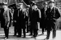 Italian immigrants Nicola Sacco, second from right foreground, and Bartolomeo Vanzetti, second from left foreground, stand in handcuffs with unidentified escorts in Massachusetts around 1927. Sacco and Vanzetti, arrested in 1920, were accused of killing a  paymaster and guard in Braintree, and stealing about $16,000.  Many believed they were convicted because of their anarchistic beliefs. Their scheduled execution was protested by ordinary and prominent men and women. The city of Boston will use a bronze sculpture of Sacco and Vanzetti to say the two men, executed 70 years ago, did not get a fair trial, said Mayor Thomas M. Menino, Tuesday, Aug. 19, 1997. On the anniversary of the executions, Saturday, Aug. 23, 1997, Menino will commission the sculpture which is to be in place by the year 2000, but it has not been decided where. (AP Photo/File)
