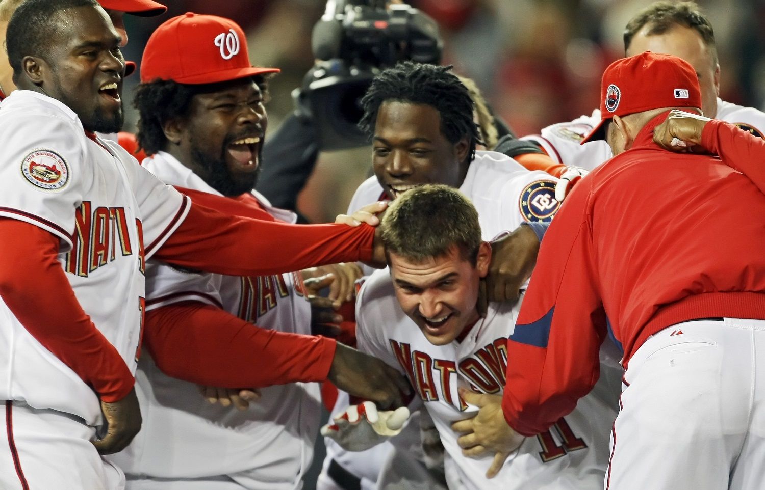 WASHINGTON - MARCH 30:  Ryan Zimmerman #11 of the Washington Nationals gets congratulated by teammates after hitting the game winning home-run in the bottom of the 9th inning during the game against the Atlanta Braves on opening day March 30, 2008 at Nationals Park in Washington, DC. The Nationals won 3-2.  (Photo by Drew Hallowell/Getty Images)