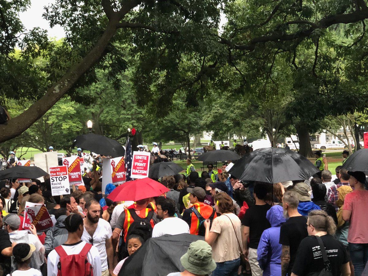 Counterprotesters demonstrate in Lafayette Square as rain falls Sunday during the Unite The Right protests. (WTOP/Keara Dowd)
