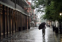 A New Orleans resident walks in the rain through Jackson Square in the French Quarter on Sunday, Aug. 28, 2005.  A mandatory evacuation has left the city nearly empty as Hurricane Katrina bears down.  (AP Photo/Dave Martin)