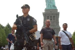 Sean Yun, a U.S. Swat Team Park Police officer stands guard outside the Statue of Liberty on New York's Liberty Island, Tuesday, Aug. 3, 2004, the first day since September 11, 2001 that tourists are allowed inside the statue.  (AP Photo/Jennifer Szymaszek)
