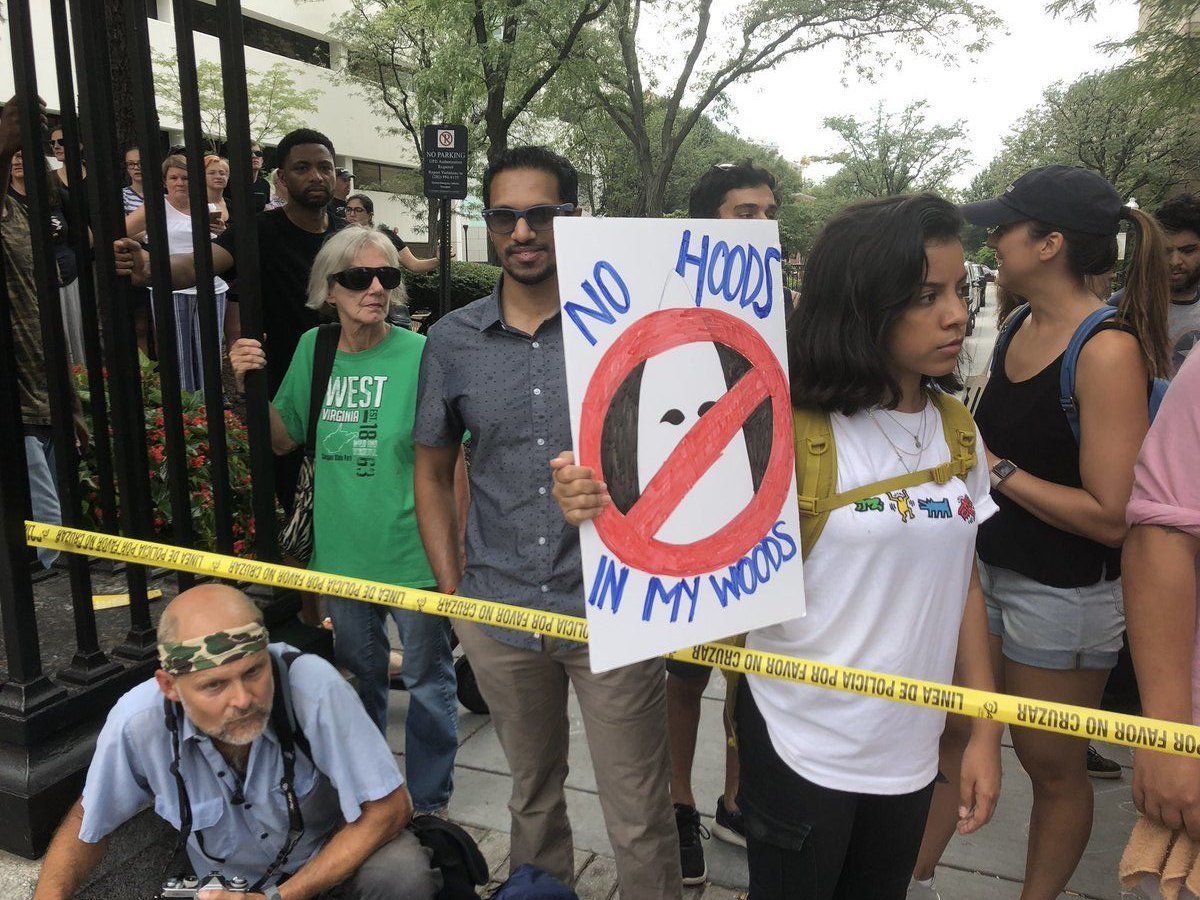 Outside the Foggy Bottom Metro station, a large group of media, counterprotesters and police greet Unite The Right 2 rally participants. (WTOP/ Max Smith)