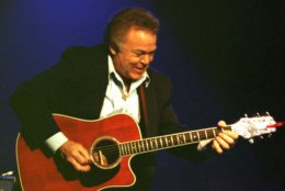 Roy Clark picks his way through a performance at his theater in Branson, Mo., Oct. 14, 1996. Clark was the first big name to have a theater in Branson and lead the way for others to come. He gives his last performance in Branson next month.  (AP Photo/John S. Stewart)