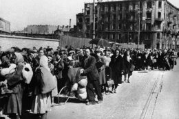 Long lines of Polish men and women moving through the streets of Warsaw en route to less destroyed districts. They are being given refreshments by Polish nurses, Sept. 15, 1944 in Warsaw. (AP Photo)