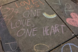 A service at Western Presbyterian Church in Northwest D.C. ends with a walk to the Foggy Bottom Metro station to write messages for rally-goers to read. (WTOP/Liz Anderson)