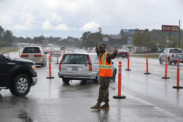 MYRTLE BEACH, SC - SEPTEMBER 11:  PFC. Traequan Shaw of the  South Carolina National Guard directs traffic onto US 501 as the South Carolina government ordered that traffic use all the lanes on the route leading away from the coast to facilitate the evacuation of people ahead of the arrival of Hurricane Florence on September 11, 2018 in Myrtle Beach, United States. Hurricane Florence is expected to arrive on Friday, possibly as a category 4 storm along the Virginia, North Carolina and South Carolina coastline.  (Photo by Joe Raedle/Getty Images)