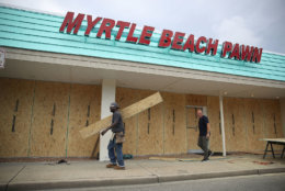 MYRTLE BEACH, SC - SEPTEMBER 11:  Jeff Bryant (L) and James Evans board the windows of a business ahead of the arrival of Hurricane Florence on September 11, 2018 in Myrtle Beach, South Carolina. Florence is expected to make landfall by late Thursday to near Category 5 strength along the Virginia, North Carolina and South Carolina coastline.  (Photo by Joe Raedle/Getty Images)