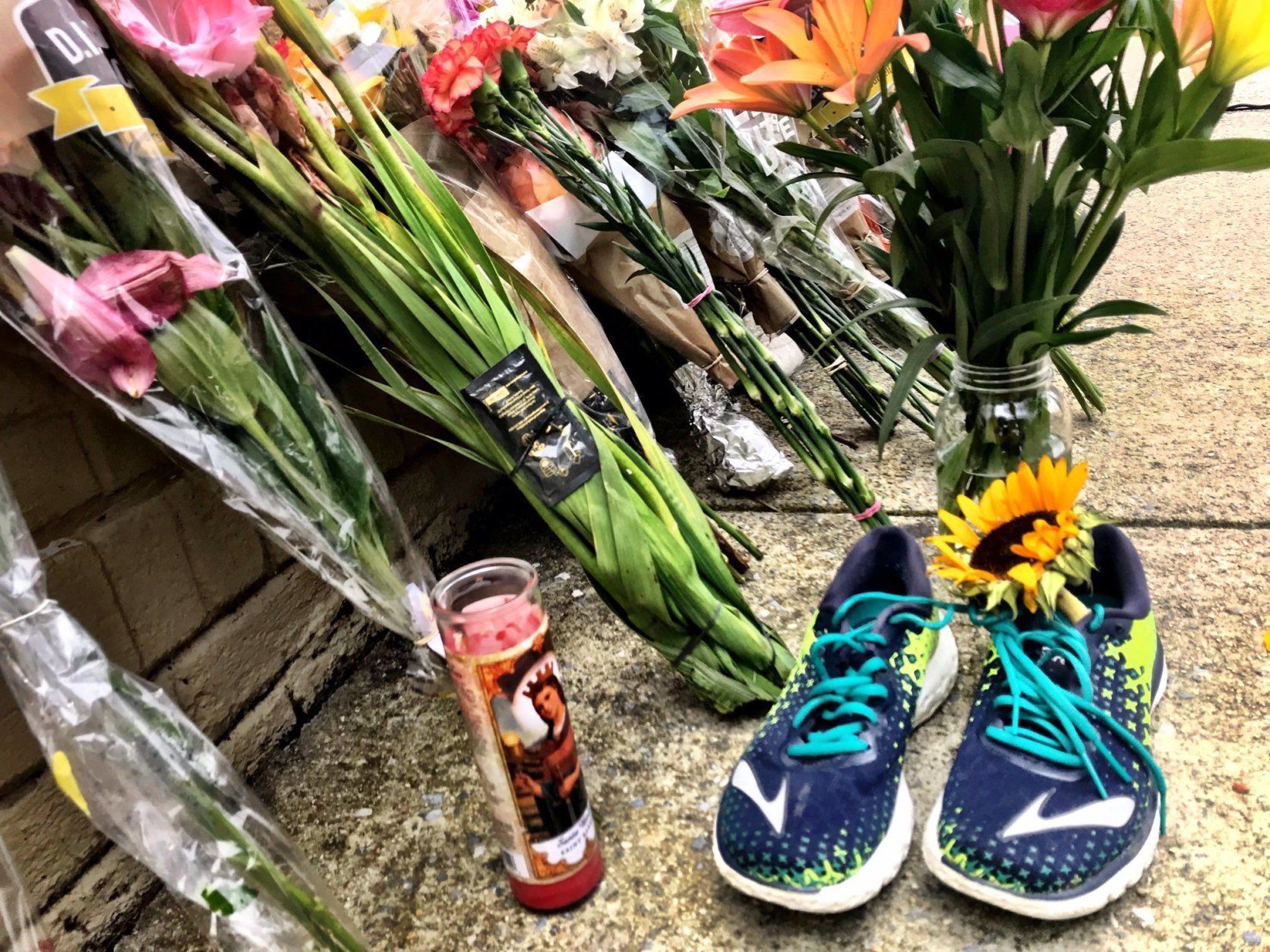 Flowers are left near the carryout where Wendy Martinez went for help after being stabbed.  (WTOP/Neal Augenstein)