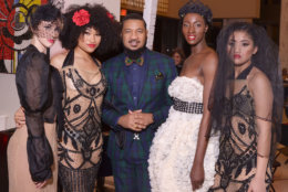 Models wearing dresses by Washington, DC-based designer Ean Williams pose with the designer following the runway show at DC Fashion Week's 2018 International Couture Collections at the Embassy of France