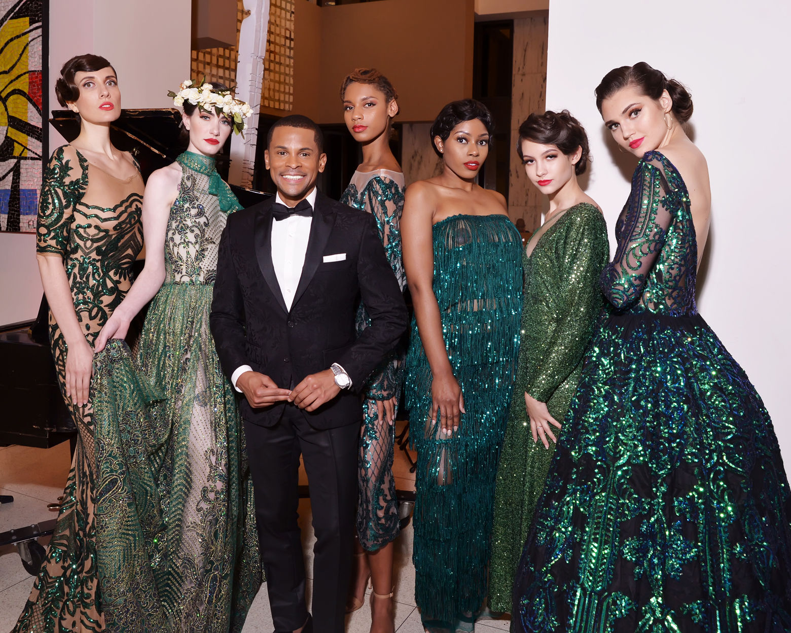 Models pose with host Guy Lambert of WPGC radio following the runway show at DC Fashion Week's 2018 International Couture Collections at the Embassy of France