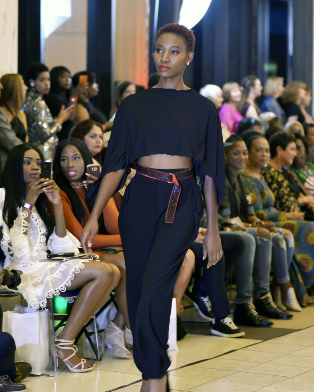 A model wearing an outfit by designer Sierra Mitchell walks the runway at DC Fashion Week's 2018 International Couture Collections at the Embassy of France