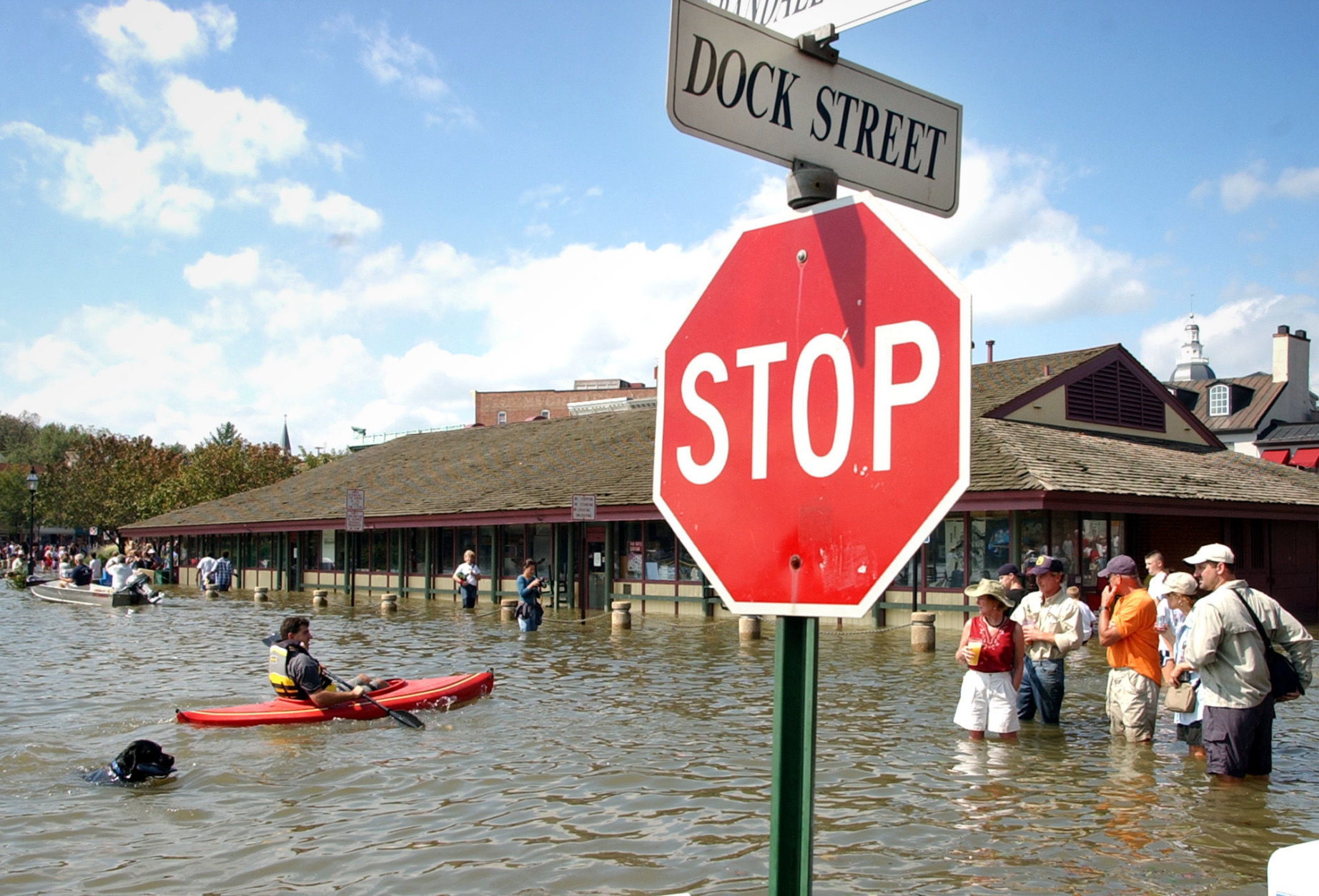 People look over the water damage from Hurricane Isabel in flooded historic downtown Annapolis, including the market house, background, Friday, Sept. 19, 2003. Rising tides fed by high winds and rains from Isabel pushed water inland to low-lying areas around the Chesapeake Bay and Potomac River early Friday, flooding homes and businesses. Tidal surges up to 7 feet were expected in some areas of southern Maryland, where high tides began late in the night. (AP Photo/Susan Walsh)