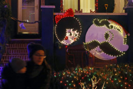 This Dec. 13, 2017, photo shows Christmas decorations depicting Salie Utz of Utz potato chips, left, and Mr. Boh of National Bohemian Beer in the Hampden neighborhood of Baltimore. Known as "The Miracle on 34th Street," the dramatically over-the-top decor along a block of row houses is perhaps Baltimore's most beloved seasonal institution, attracting thousands of gawkers each December. (AP Photo/Patrick Semansky)