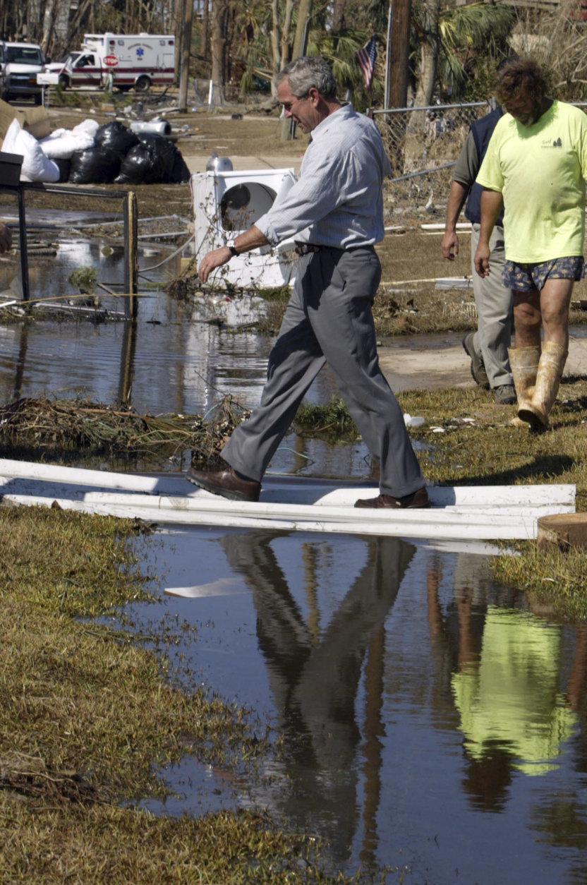 President George W. Bush tours an area damaged by Hurricane Ivan Sunday, Sept. 19, 2004 in Pensacola, Fla. (AP Photo/Charles Dharapak)