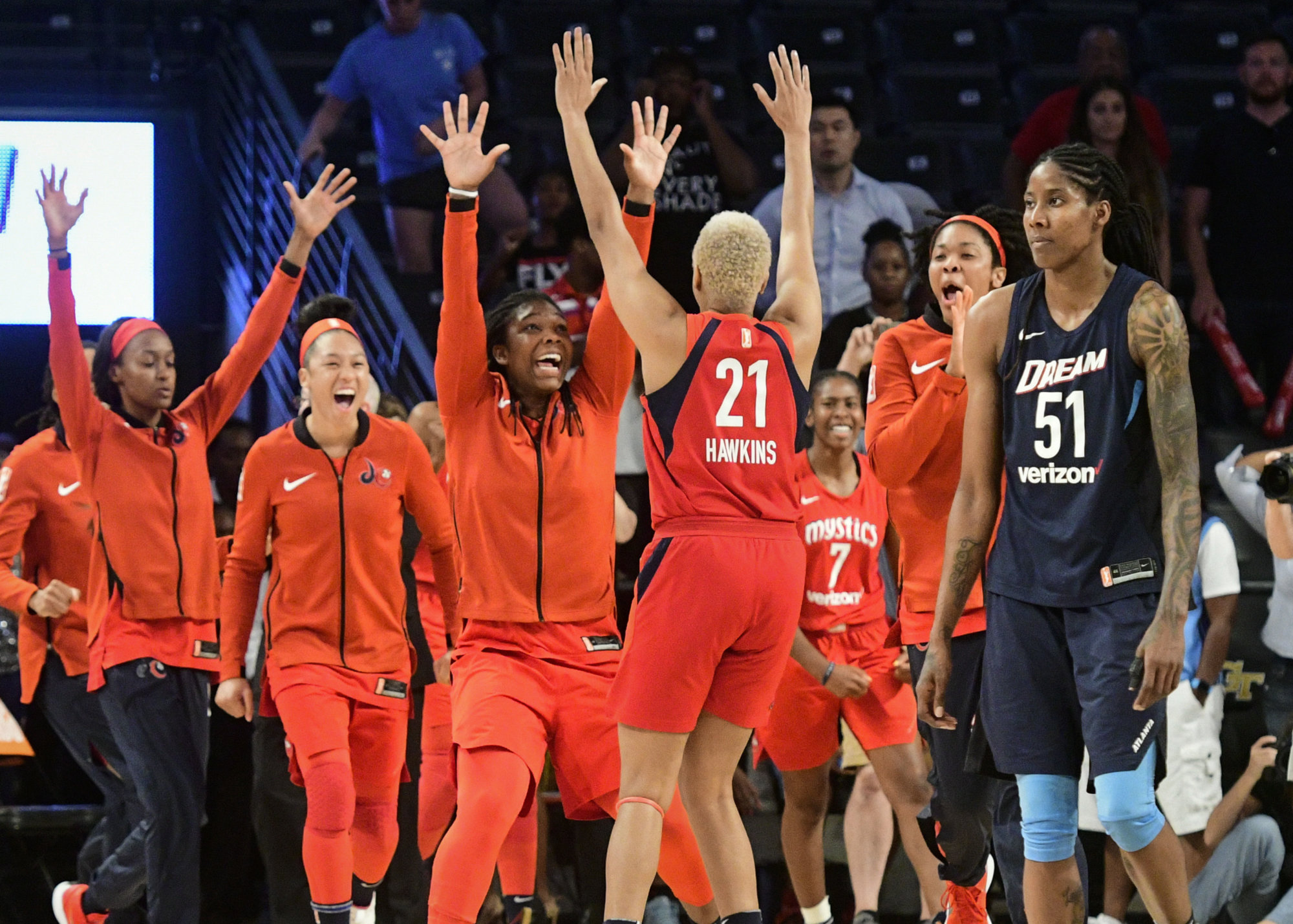 Washington Mystics center Krystal Thomas, second from right, forward Tianna Hawkins (21), forward Myisha Hines-Allen, fourth from right, and forward Aerial Powers, second from left, celebrate as Atlanta Dream forward Jessica Brelaat stands nearby, at the end of Game 5 in a WNBA basketball playoffs semifinal Tuesday, Sept. 4, 2018, in Atlanta. The Mystics won 86-8 to advance to the finals. (AP Photo/John Amis)