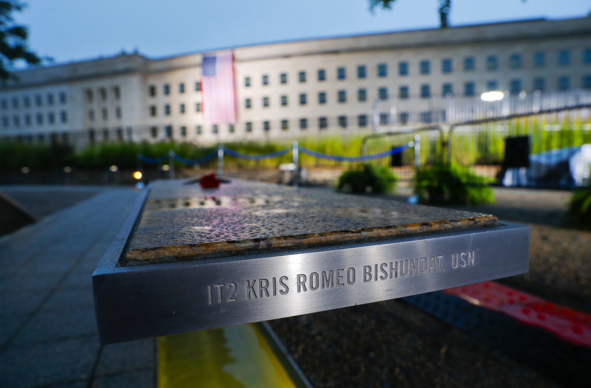 The National 9/11 Pentagon Memorial is seen in the foreground after the U.S. flag is unfurled Tuesday, Sept. 11, 2018, at the Pentagon on the 17th anniversary of the Sept. 11, 2001, terrorist attacks. (AP Photo/Pablo Martinez Monsivais)