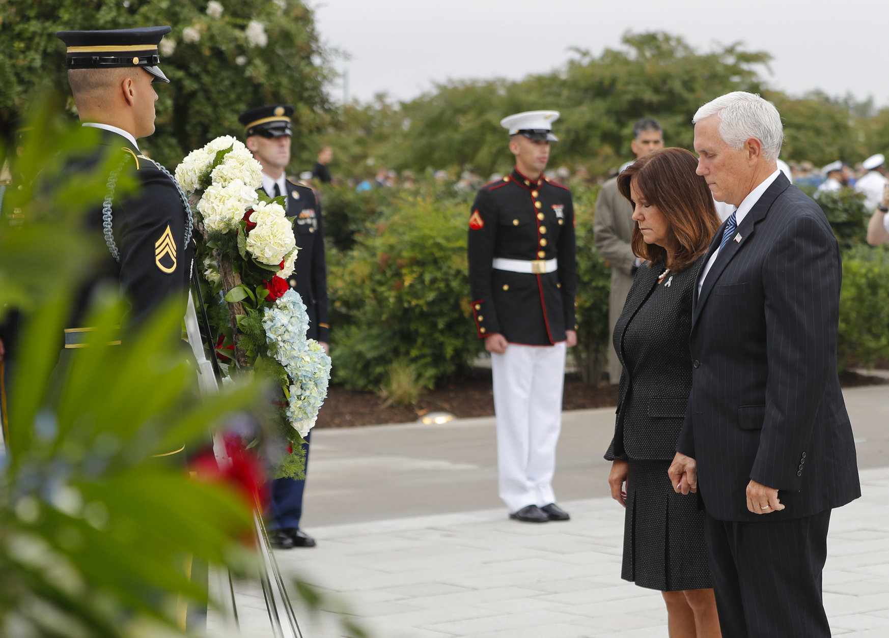 Vice President Mike Pence and his wife Karen Pence, lower their heads after laying a wreath during the September 11th Pentagon Memorial Observance at the Pentagon on the 17th anniversary of the September 11th attacks, Tuesday, Sept. 11, 2018. (AP Photo/Pablo Martinez Monsivais)