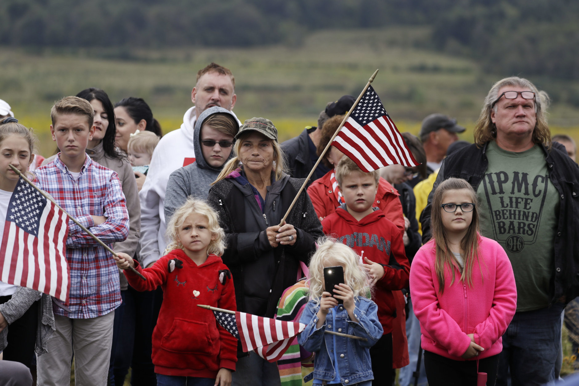 Audience members attend the September 11th Flight 93 Memorial Service, Tuesday, Sept. 11, 2018, in Shanksville, Pa. President Donald Trump is marking 17 years since the worst terrorist attack on U.S. soil by visiting the Pennsylvania field that became a Sept. 11 memorial.  (AP Photo/Evan Vucci)