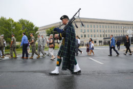 A musician plays his bagpipes as he walks with visitors and guests before the start of the September 11th Pentagon Memorial Observance at the Pentagon on the 17th anniversary of the September 11th attacks, Tuesday, Sept. 11, 2018. (AP Photo/Pablo Martinez Monsivais)