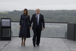 President Donald Trump and first lady Melania Trump, walk along the September 11th Flight 93 memorial, Tuesday, Sept. 11, 2018, in Shanksville, Pa., escorted by  (AP Photo/Evan Vucci)