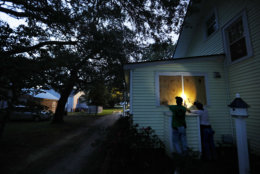 Russell Meadows, left, helps neighbor Rob Muller board up his home ahead of Hurricane Florence in Morehead City, N.C., Tuesday, Sept. 11, 2018. Florence exploded into a potentially catastrophic hurricane Monday as it closed in on North and South Carolina, carrying winds up to 140 mph (220 kph) and water that could wreak havoc over a wide stretch of the eastern United States later this week. (AP Photo/David Goldman)