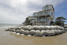 Sand bags surround homes on North Topsail Beach, N.C., Wednesday, Sept. 12, 2018, as Hurricane Florence threatens the coast. (AP Photo/Chuck Burton)