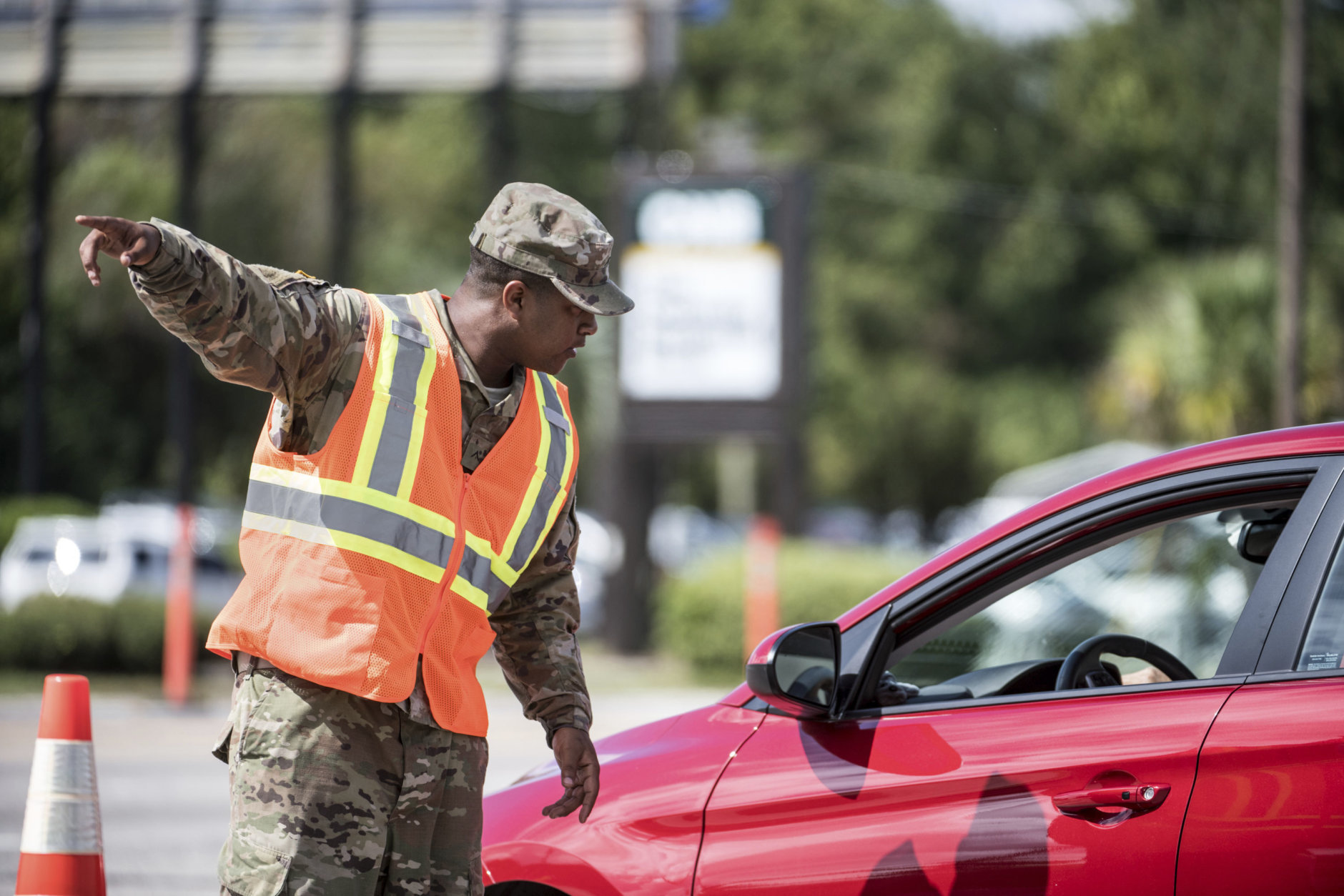A National Guardsman directs traffic onto U.S. Highway 501 as Hurricane Florence approaches the East Coast Wednesday, Sept. 12, 2018, near Conway, S.C. Time is running short to get out of the way of Hurricane Florence, a monster of a storm that has a region of more than 10 million people in its potentially devastating sights. (AP Photo/Sean Rayford)
