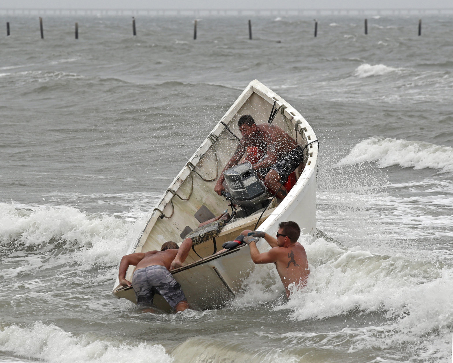 Fishermen launch a boat as they attempt to recover their haul-seine fishing net, Thursday, Sept. 13, 2018, in Virginia Beach, Va., as Hurricane Florence moves towards the eastern shore. (AP Photo/Alex Brandon)