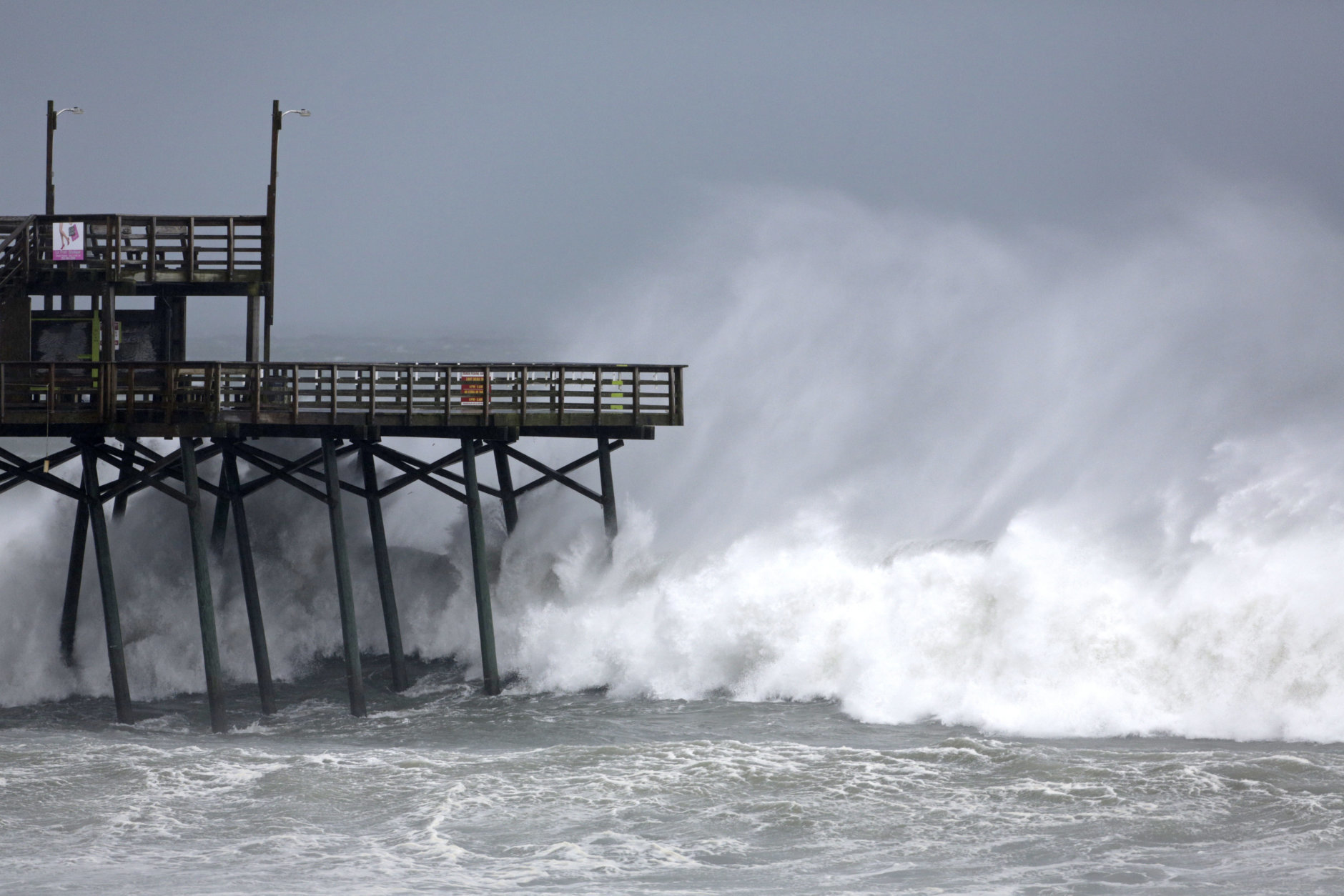 Waves from Hurricane Florence pound the Bogue Inlet Pier in Emerald Isle N.C., Thursday, Sept. 13, 2018. (AP Photo/Tom Copeland)
