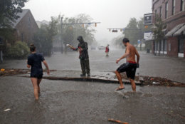 People survey the damage caused by Hurricane Florence on Front Street in downtown New Bern, N.C., on Friday, Sept. 14, 2018. (AP Photo/Chris Seward)