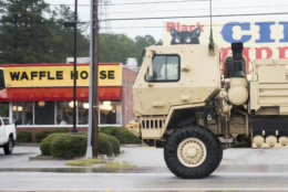 A National Guard vehicle drives past a Waffle House as Hurricane Florence slowly moves across the East Coast Friday, Sept. 14, 2018, in Florence, S.C. (AP Photo/Sean Rayford)