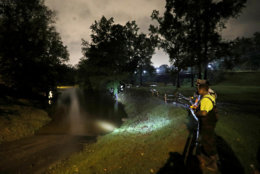 A group of local fishermen keep an eye on the Cape Fear River as they stage for potential water rescues while additional flooding remains a threat from Florence, in Fayetteville, N.C., Sunday, Sept. 16, 2018. (AP Photo/David Goldman)