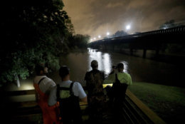A group of local fishermen keep an eye on the Cape Fear River as they stage for potential water rescues while additional flooding remains a threat from Florence, in Fayetteville, N.C., Sunday, Sept. 16, 2018. (AP Photo/David Goldman)