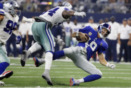New York Giants quarterback Eli Manning (10) falls after taking a hit from Dallas Cowboys linebacker Jaylon Smith (54) during the second half of an NFL football game in Arlington, Texas, Sunday, Sept. 16, 2018. (AP Photo/Michael Ainsworth)