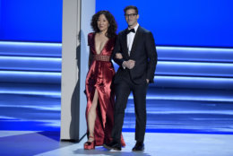 Sandra Oh, left, and Andy Samberg appear on stage to present the award for outstanding directing for a comedy series at the 70th Primetime Emmy Awards on Monday, Sept. 17, 2018, at the Microsoft Theater in Los Angeles. (Photo by Chris Pizzello/Invision/AP)