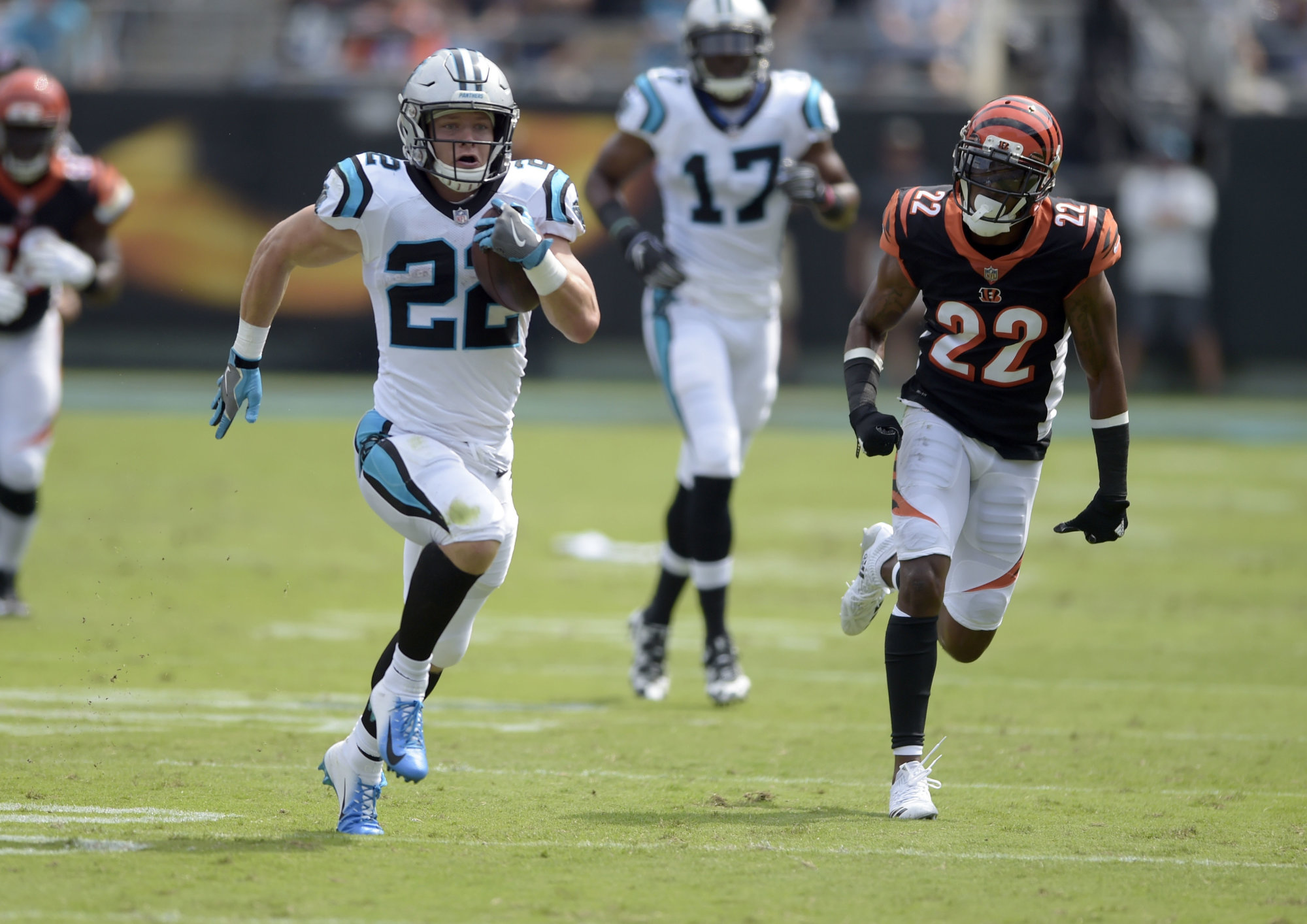 Carolina Panthers' Christian McCaffrey, left, runs past Cincinnati Bengals' William Jackson, right, during the first half of an NFL football game in Charlotte, N.C., Sunday, Sept. 23, 2018. (AP Photo/Mike McCarn)