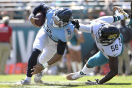 Jacksonville Jaguars defensive end Dante Fowler (56) tackles Tennessee Titans quarterback Marcus Mariota (8) during the second half of an NFL football game, Sunday, Sept. 23, 2018, in Jacksonville, Fla. (AP Photo/Phelan M. Ebenhack)