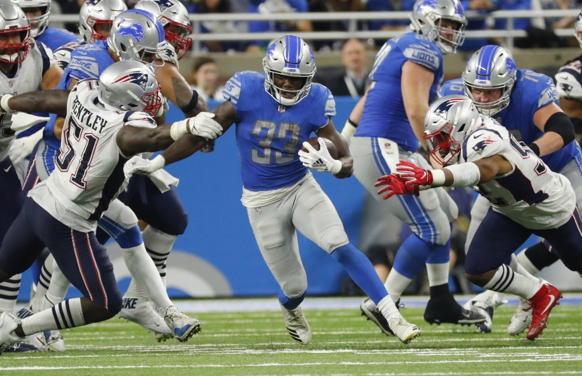 Detroit Lions running back Kerryon Johnson (33) breaks through the New England Patriots line during the second half of an NFL football game, Sunday, Sept. 23, 2018, in Detroit. (AP Photo/Rick Osentoski)