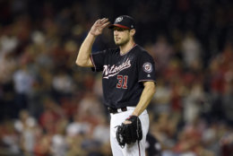 Washington Nationals starting pitcher Max Scherzer gestures from the mound after he recorded his 300th strikeout of the season during the seventh inning of a baseball game against the Miami Marlins, Tuesday, Sept. 25, 2018, in Washington. (AP Photo/Nick Wass)